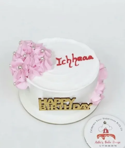 White cake with pink rosettes and pearls