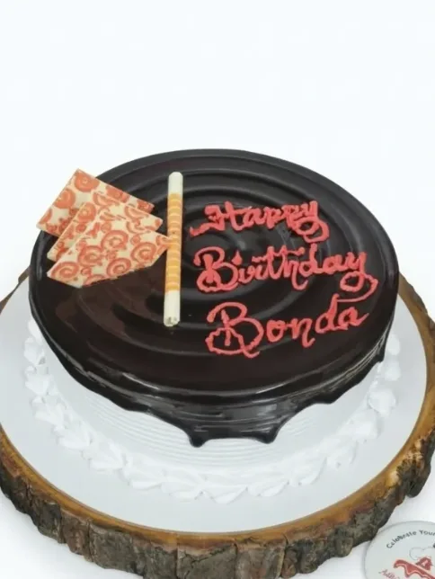Chocolate glaze birthday cake with white chocolate garnish